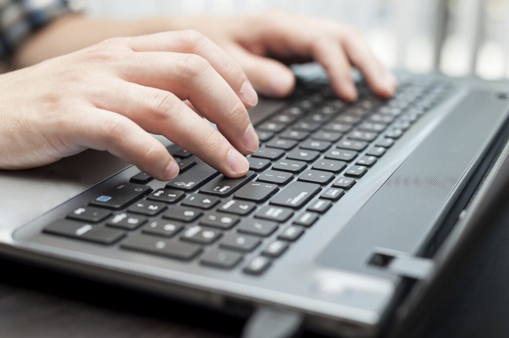 Fingers Using Laptop Keyboard