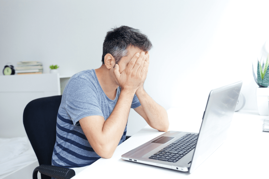 Man Distressed at Laptop